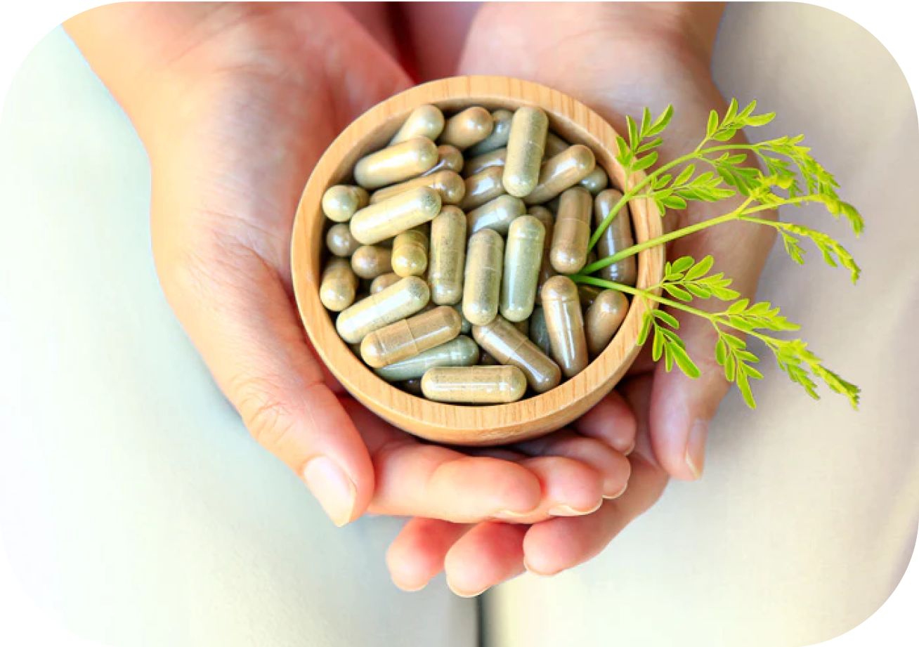 Hands holding a wooden bowl filled with probiotic supplements